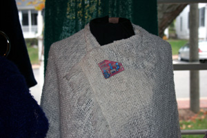 Display of knitted shaw with jewelry